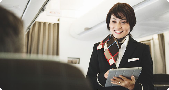 Naoero Airlines cabin crew member with a tablet